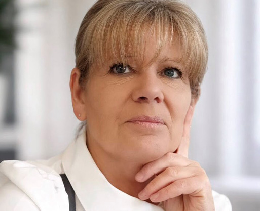 thoughtful woman with short blonde hair wearing a white shirt gazing confidently with five expressions of wisdom