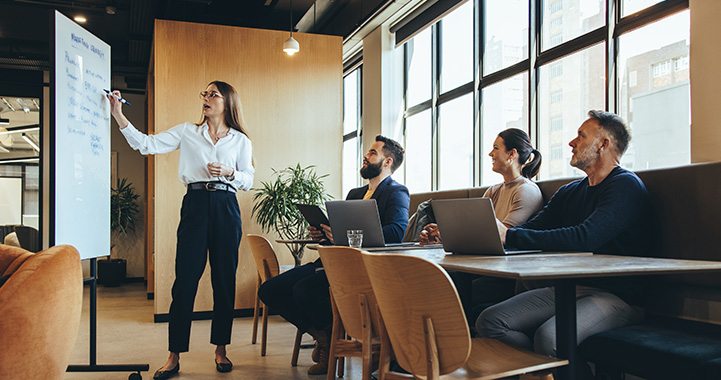man wearing glasses discussing paperwork in a bright office setting engaging conversation about three important topics