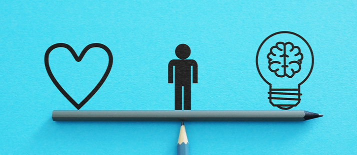 icon representing love, a person, and a brain inside a light bulb, balanced on a pencil against a blue background highlighting the importance of both emotional and intellectual aspects in life, 2 perspectives on well-being